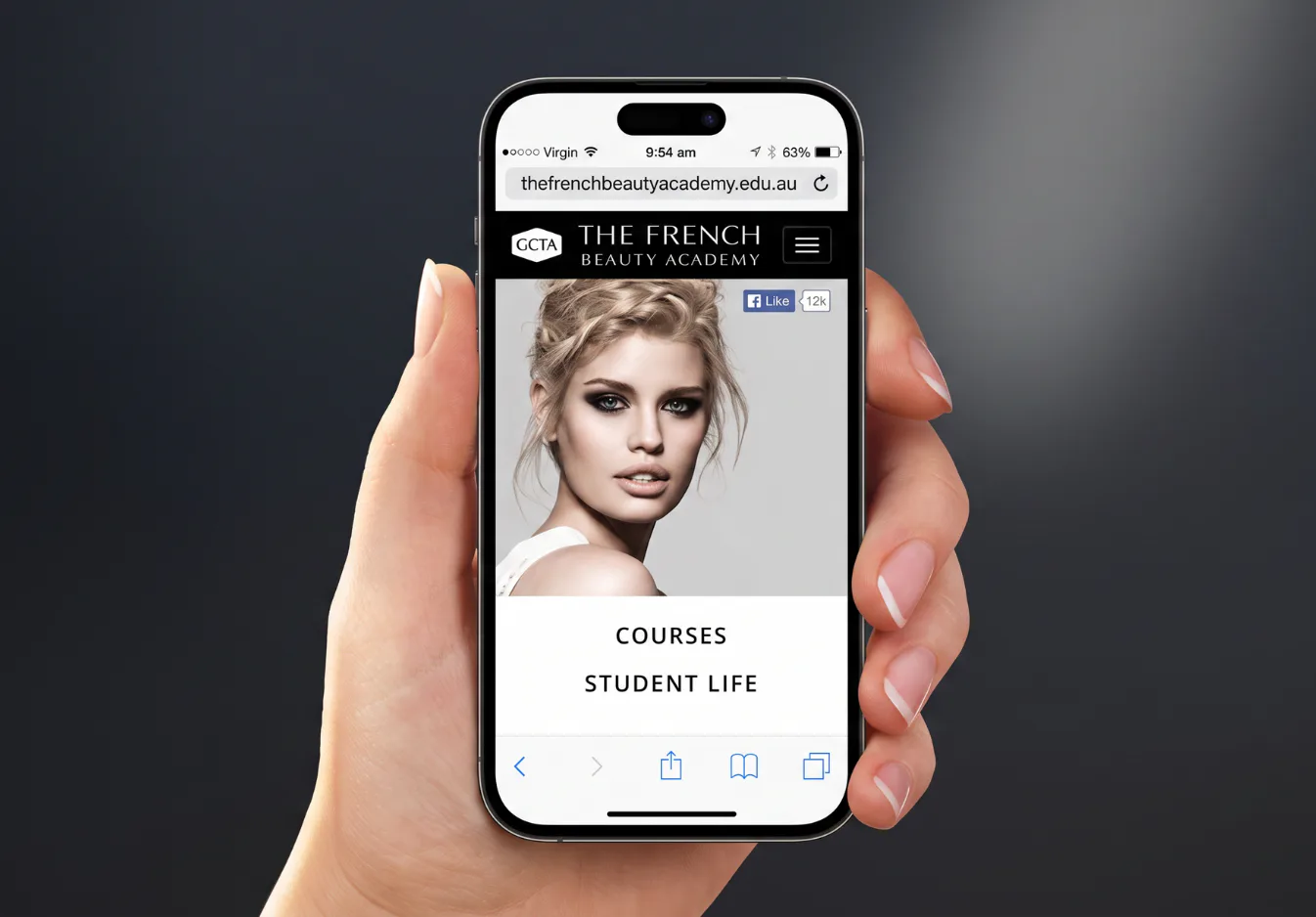 Hand holding smartphone displaying The French Beauty Academy website with professional beauty industry model portrait, navigation menu showing Courses and Student Life options, and Facebook engagem...